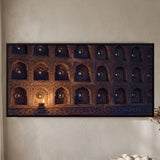 Single Lit Diya Illuminating a Wall of Mirrored Niches
