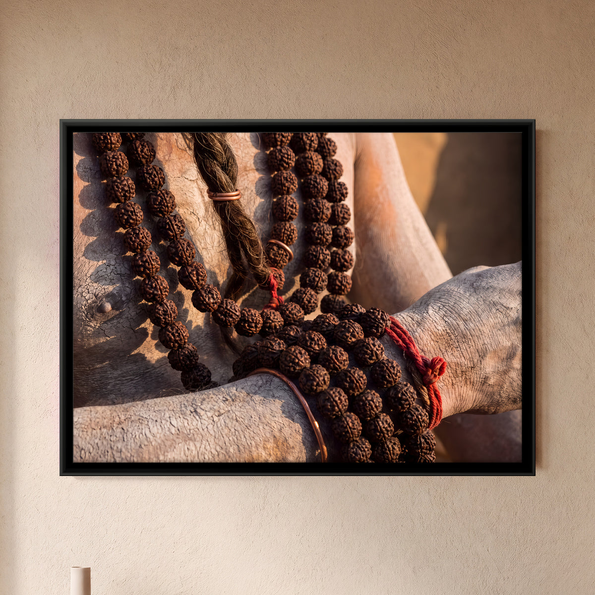 Rudraksha Beads in Hand - framed canvas art hung on a wall