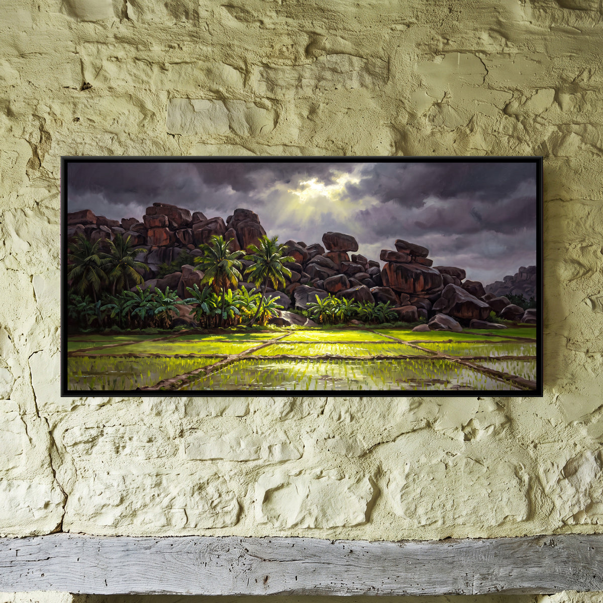Monsoon Paddy Fields below Hampi's Boulders - framed canvas art hung on a wall