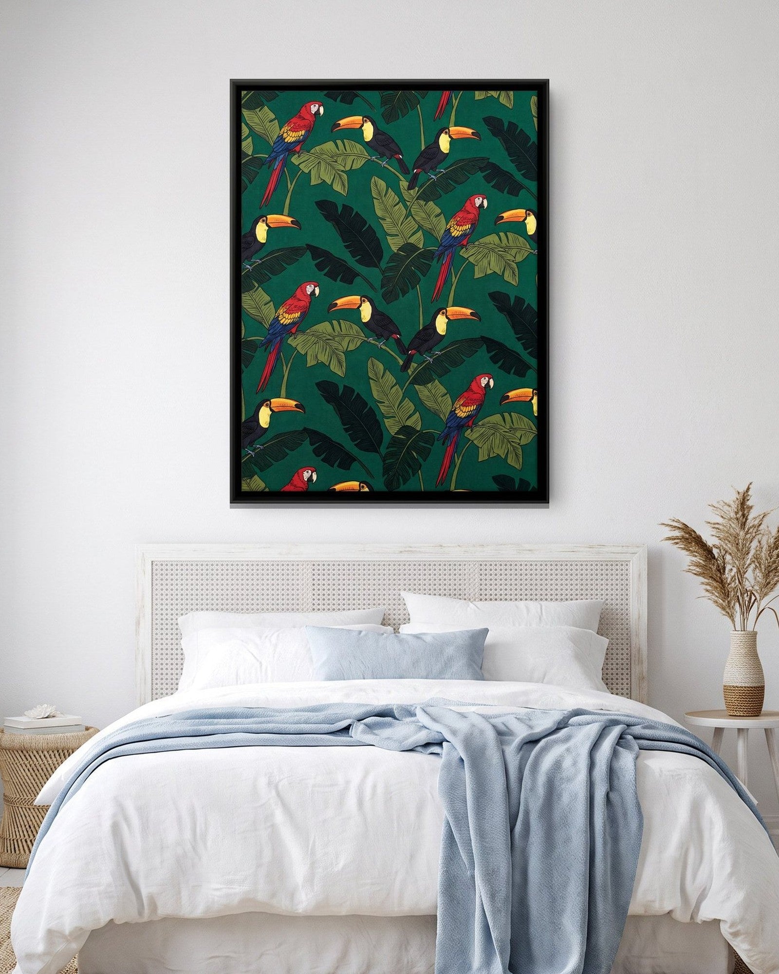 A canvas of macaws and toucans among banana leaves above a bed in a bright bedroom