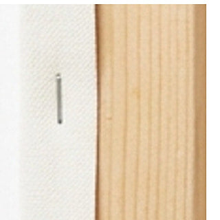 A staple line running down the back of the pine bar, holding the canvas under tension